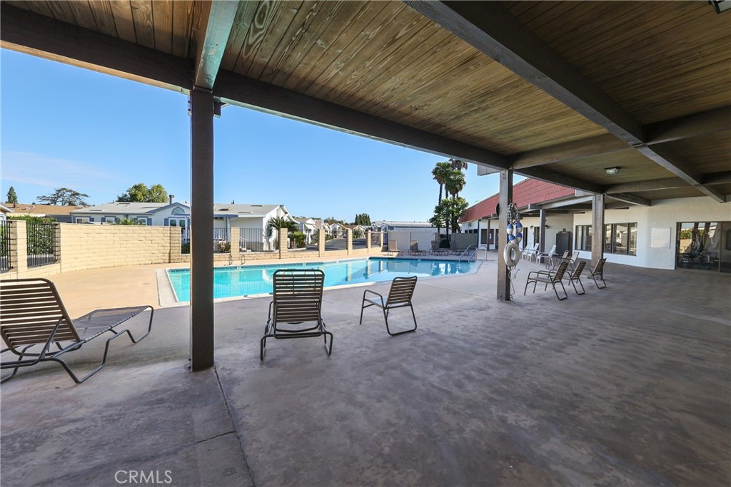Expansive clubhouse pool area featuring a heated pool with ample space for recreation and relaxation. - 1201 W Valencia Drive 13, Fullerton CA 92833 - photo 37