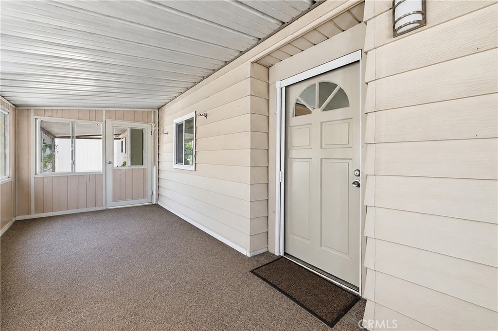 This enclosed patio provides extra living space—perfect for a home office, sitting room, hobby room, or whatever best su - 1201 W Valencia Drive 69, Fullerton CA 92833 - photo 2