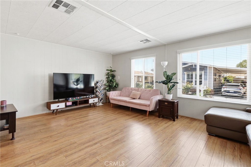 This spacious living room offers an abundance of natural light, creating a bright and welcoming atmosphere. - 1201 W Valencia Drive 69, Fullerton CA 92833 - photo 5