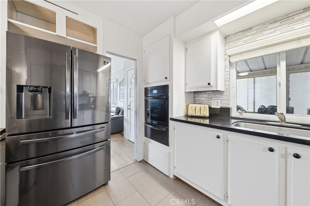 The kitchen features stainless steel appliances, offering both style and functionality. - 1201 W Valencia Drive 69, Fullerton CA 92833 - photo 7