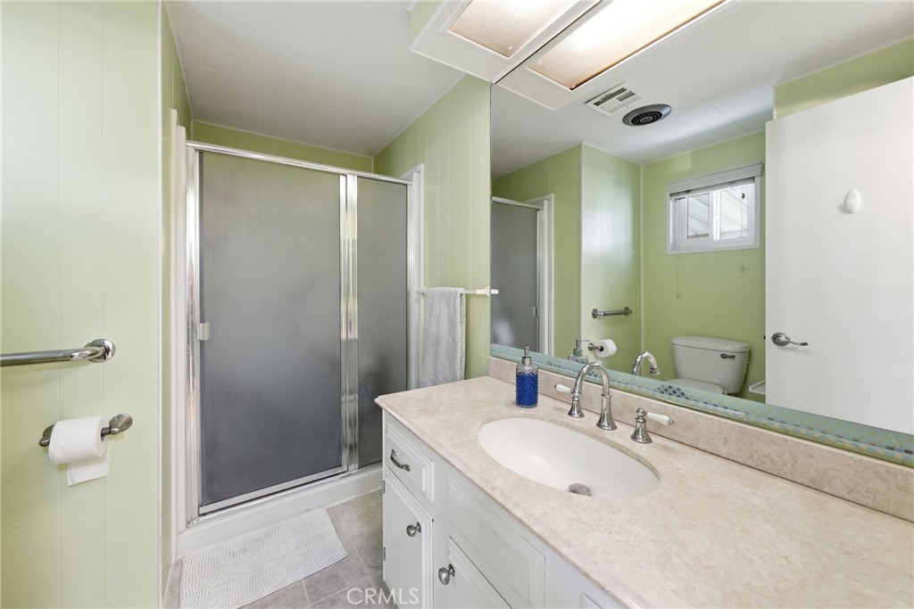 The three-quarter bathroom features a bidet toilet and a convenient closet for additional storage. - 1201 W Valencia Drive 69, Fullerton CA 92833 - photo 18