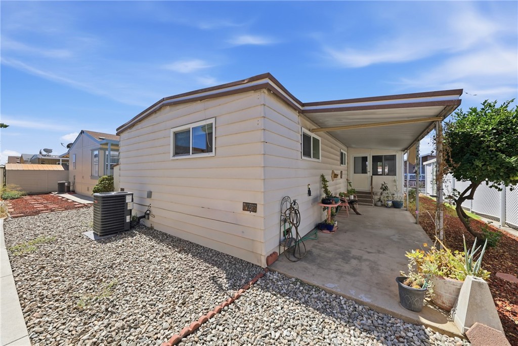 The rear of the home features a low-maintenance yard and a brand-new A/C compressor installed April, 2026. - 1201 W Valencia Drive 69, Fullerton CA 92833 - photo 23