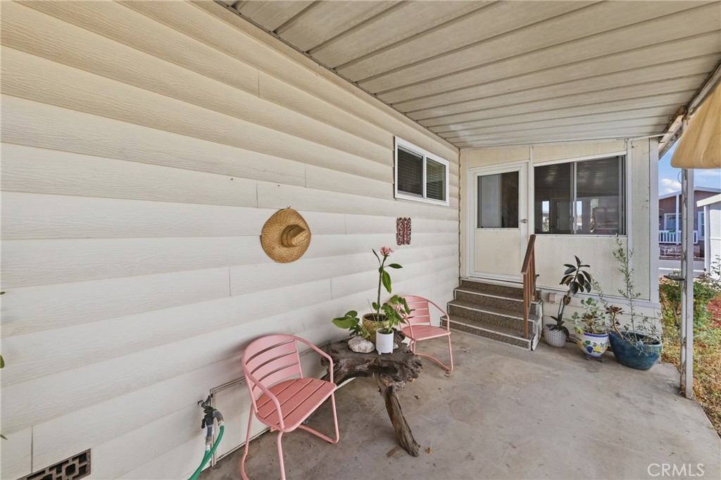 An inviting, cozy patio—perfect for intimate evenings—with a convenient water spigot for potted plants and direct access - 1201 W Valencia Drive 69, Fullerton CA 92833 - photo 24