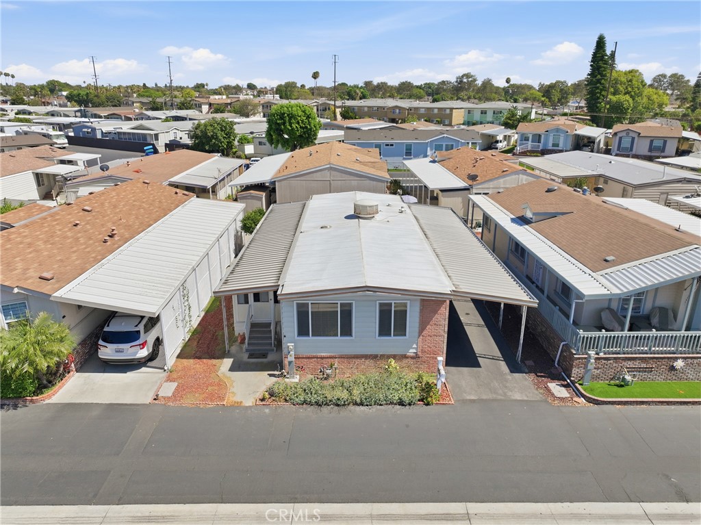 Aerial drone view showcasing the home, its lot, and the surrounding neighbors. - 1201 W Valencia Drive 69, Fullerton CA 92833 - photo 26