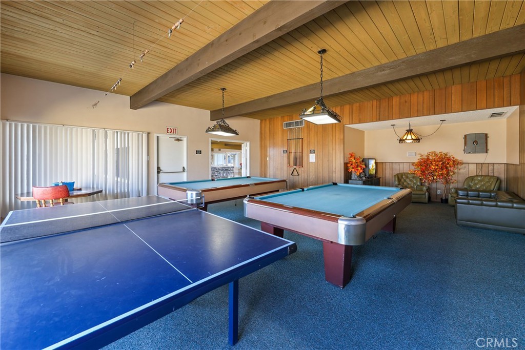 The clubhouse game room features a ping-pong table and billiards tables for recreation and friendly competition. - 1201 W Valencia Drive 69, Fullerton CA 92833 - photo 36
