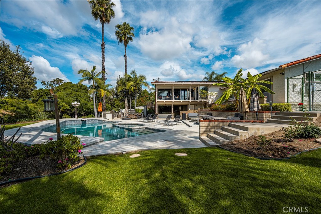 Set on a nearly half-acre lot, the present owners just had a birthday party with over 150 guests in this tropical paradi - 1360 Dana Pl, Fullerton CA 92831 - photo 1