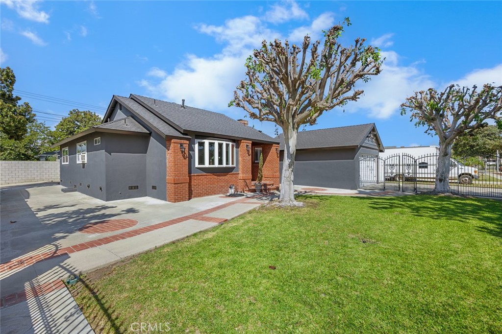 Entire yard front and back enclosed with beautiful brick and wrought iron. - 1501 Revere, Fullerton CA 92831 - photo 1