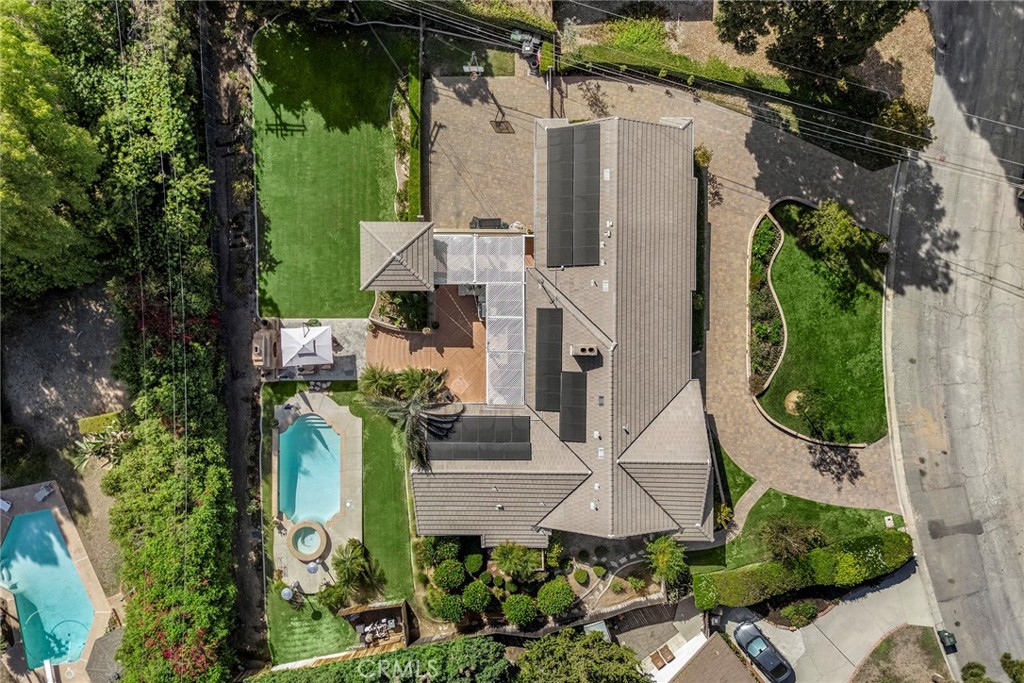 A dramatic aerial view showcases the home’s expansive nearly half-acre lot, resort-style pool and spa, sprawling single- - 2100 Yucca Avenue, Fullerton CA 92835 - photo 4