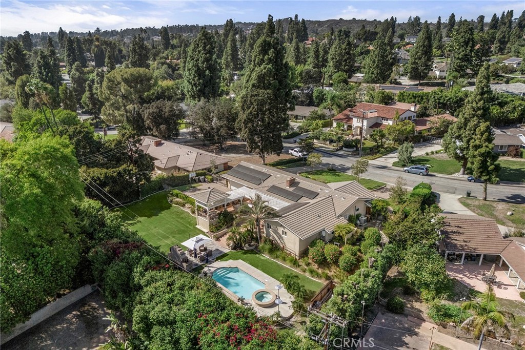 This sweeping aerial view highlights the home’s expansive nearly half-acre setting, lush grounds, resort-style pool and - 2100 Yucca Avenue, Fullerton CA 92835 - photo 5