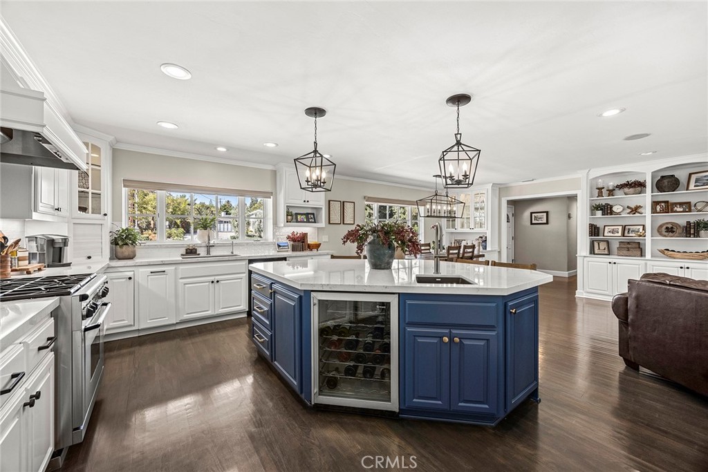 This stunning chef’s kitchen showcases crisp white cabinetry, quartz countertops, professional-style stainless steel app - 2100 Yucca Avenue, Fullerton CA 92835 - photo 16