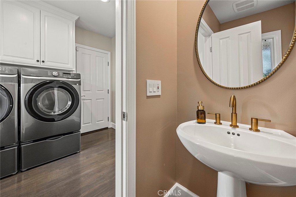 A beautifully finished powder room sits conveniently adjacent to the spacious laundry room, featuring abundant built-in - 2100 Yucca Avenue, Fullerton CA 92835 - photo 17