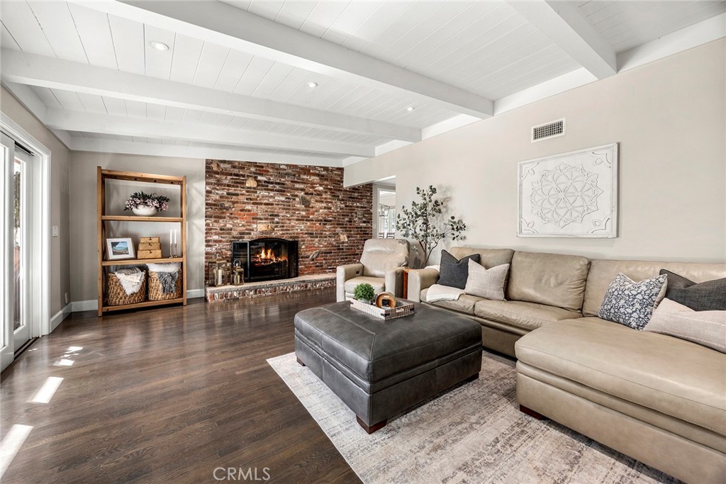 Warm and welcoming family room with a brick fireplace, custom built-in cabinetry and French doors opening to the backyar - 2100 Yucca Avenue, Fullerton CA 92835 - photo 19