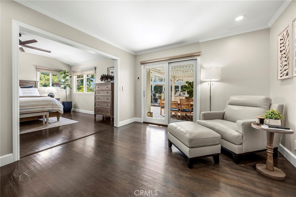 Light-filled sitting area as you enter the primary bedroom offers a peaceful retreat with rich wood flooring and conveni - 2100 Yucca Avenue, Fullerton CA 92835 - photo 23