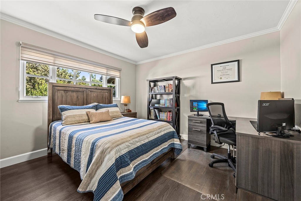 A spacious secondary bedroom offers beautiful hardwood floors, abundant natural light, and ample room for a dedicated st - 2100 Yucca Avenue, Fullerton CA 92835 - photo 34