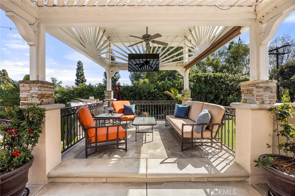 Inviting covered outdoor lounge creates a comfortable setting for relaxing and entertaining while overlooking the ground - 2100 Yucca Avenue, Fullerton CA 92835 - photo 40