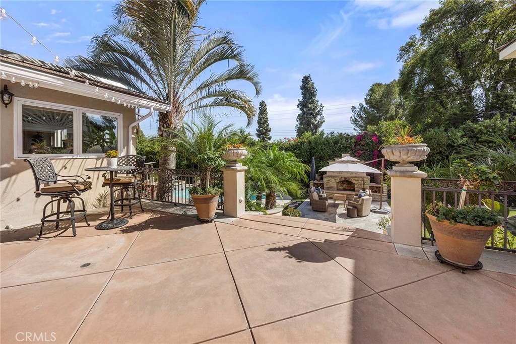 Elevated patio overlooks the pool, outdoor fireplace and lush backyard, beautifully connecting the home’s multiple outdo - 2100 Yucca Avenue, Fullerton CA 92835 - photo 42