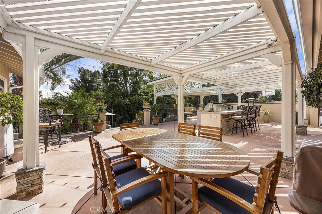Impressive covered outdoor entertaining area features a built-in kitchen and bar with abundant seating and gathering spa - 2100 Yucca Avenue, Fullerton CA 92835 - photo 43