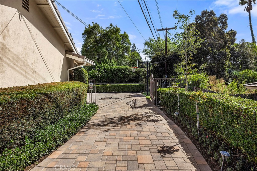 Private gated driveway and paved sport area add versatility to the home’s expansive outdoor amenities. - 2100 Yucca Avenue, Fullerton CA 92835 - photo 49