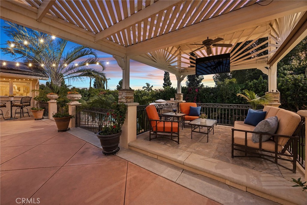 Twilight lighting transforms the covered outdoor lounge into a warm and inviting evening retreat. - 2100 Yucca Avenue, Fullerton CA 92835 - photo 51