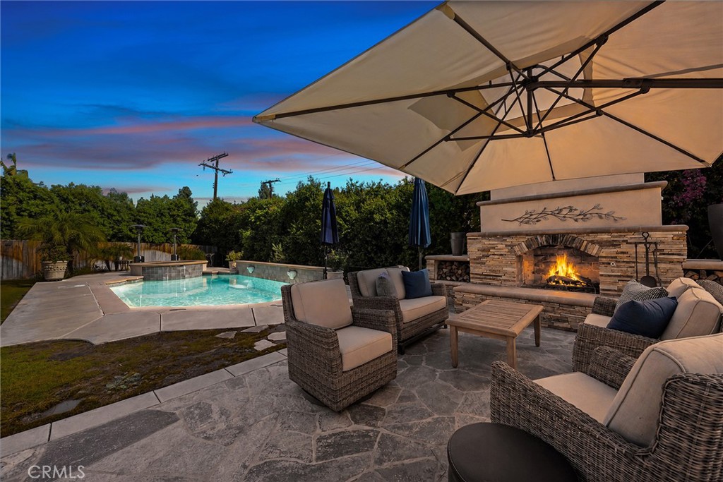 Poolside fireplace and lounge create a spectacular setting for relaxing and entertaining under the evening sky. - 2100 Yucca Avenue, Fullerton CA 92835 - photo 54