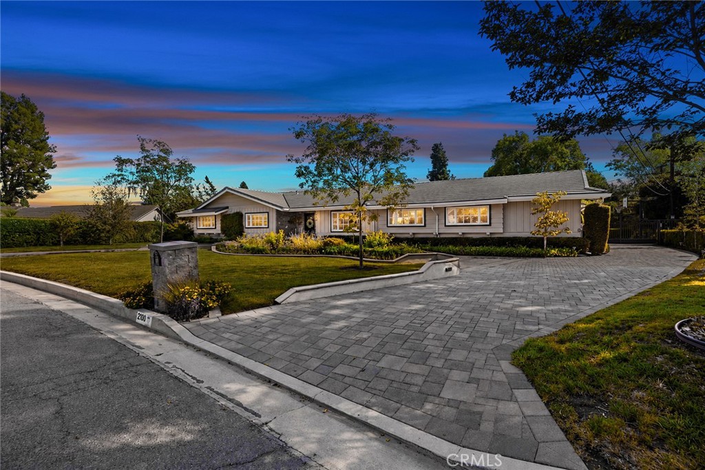 Beautiful twilight curb appeal highlights the home’s expansive single-story design, manicured landscaping and impressive - 2100 Yucca Avenue, Fullerton CA 92835 - photo 55