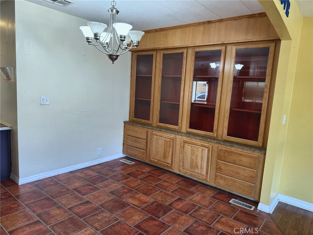 Dining area with built-in cabinetry and display storage - 2851 Rolling Hills 187, Fullerton CA 92835 - photo 4