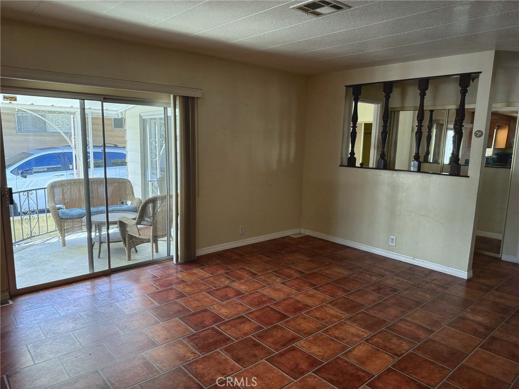 Additional living and dining space with sliding glass door - 2851 Rolling Hills 187, Fullerton CA 92835 - photo 5
