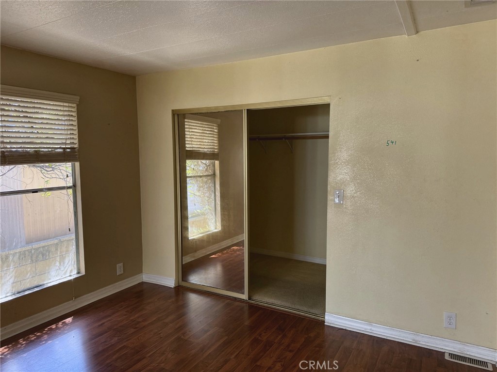 Primary bedroom with mirrored closet doors and generous storage - 2851 Rolling Hills 187, Fullerton CA 92835 - photo 7