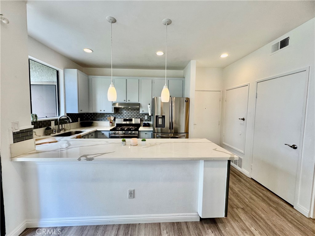 Large island perfect for gathering with guests. - 10580 Lakeside Drive N E, Garden Grove CA 92840 - photo 1