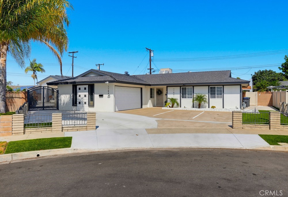Front of house showing side ADU parking and private gate - 11841 Garnet, Garden Grove CA 92845 - photo 10