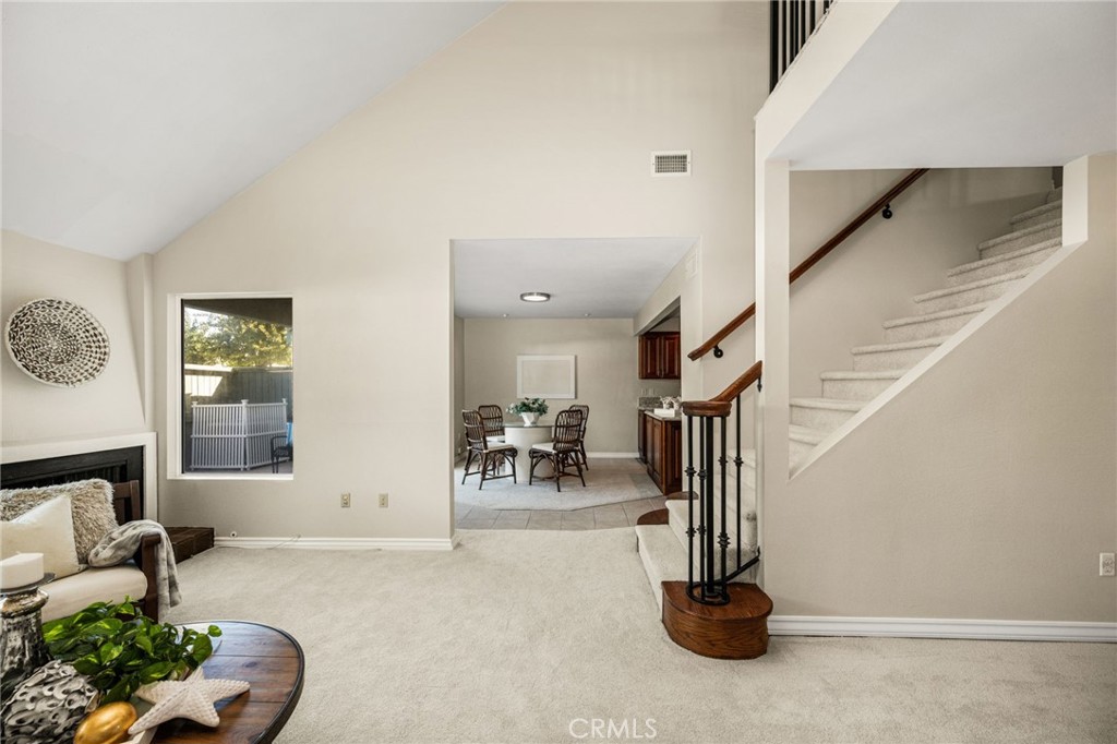 An impressive two-story living area features an open staircase and abundant natural light. - 12632 Romaine Wy, Garden Grove CA 92845 - photo 6