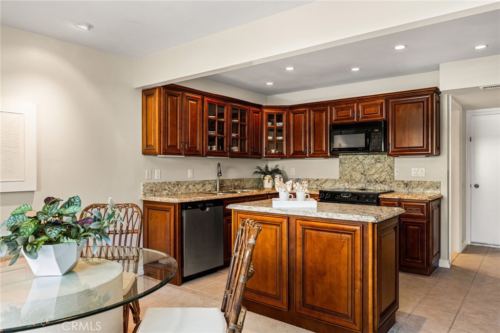 Beautiful custom cabinetry, granite countertops and a center island make this kitchen a standout. - 12632 Romaine Wy, Garden Grove CA 92845 - photo 14