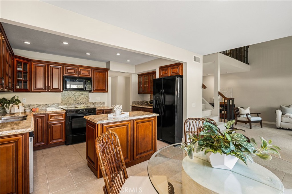 An inviting kitchen and dining space offers an easy connection to the adjoining living room. - 12632 Romaine Wy, Garden Grove CA 92845 - photo 16