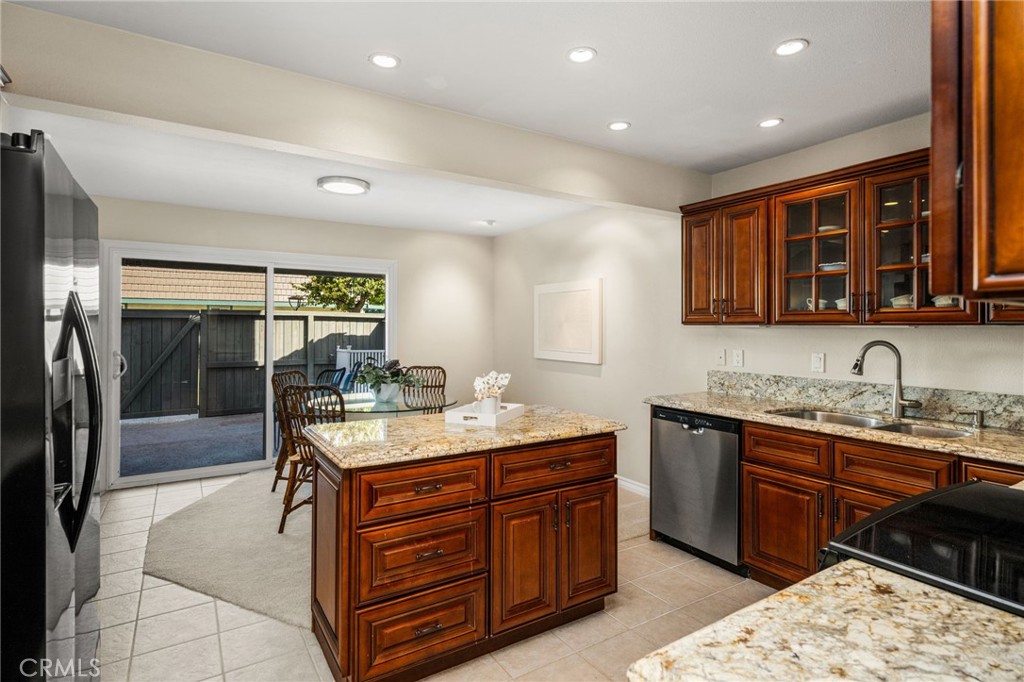 A convenient center island provides additional workspace and storage, with the dining area and patio just steps away. - 12632 Romaine Wy, Garden Grove CA 92845 - photo 20