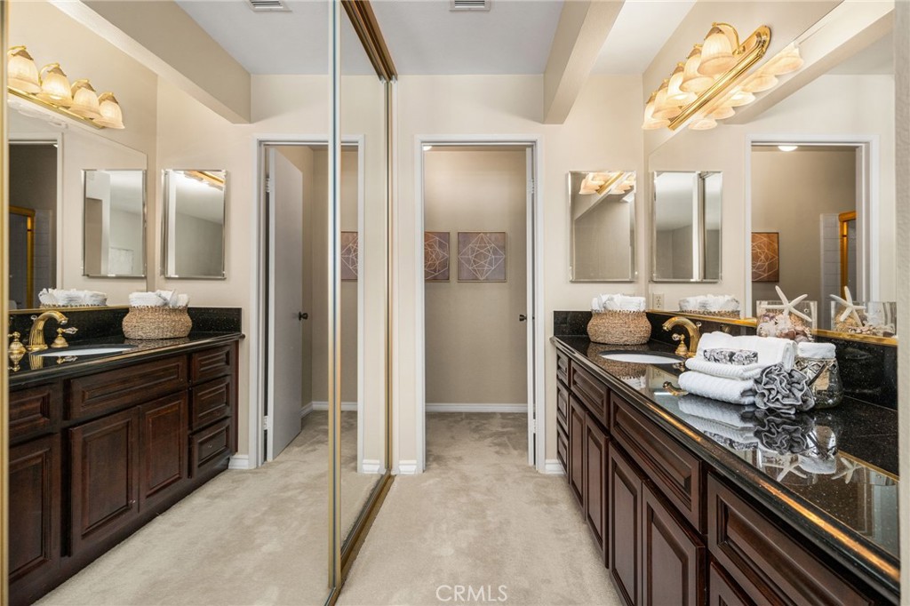 Generous primary suite offers room to relax, with a convenient connection to the dressing and vanity area. 41 Pr - 12632 Romaine Wy, Garden Grove CA 92845 - photo 33