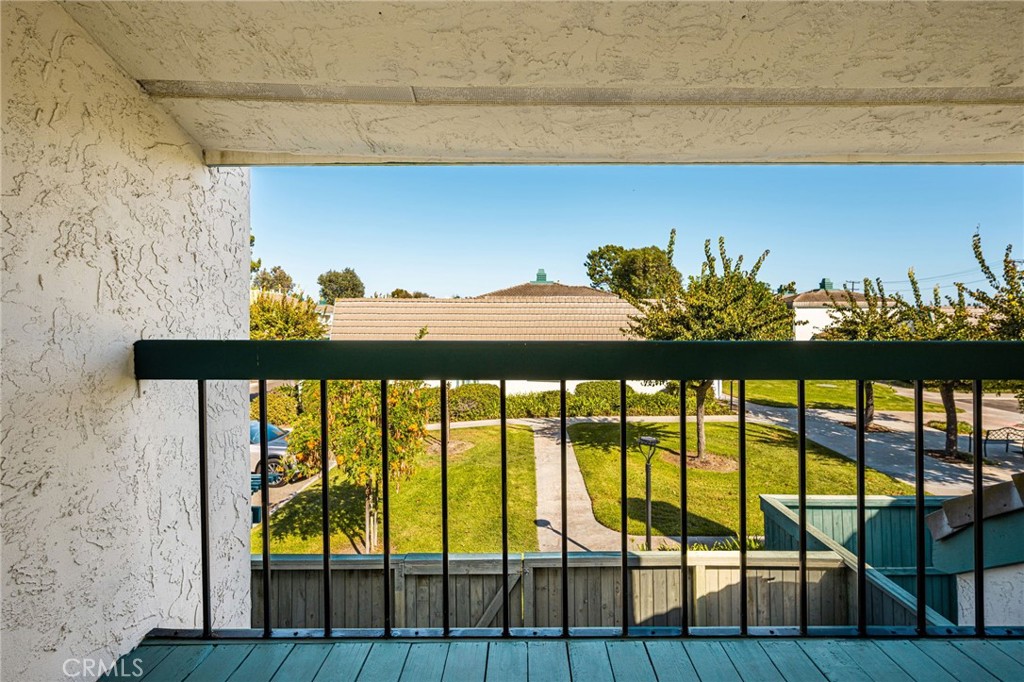 Covered balcony overlooks the community greenbelt—a peaceful setting for fresh air and morning coffee. - 12632 Romaine Wy, Garden Grove CA 92845 - photo 35