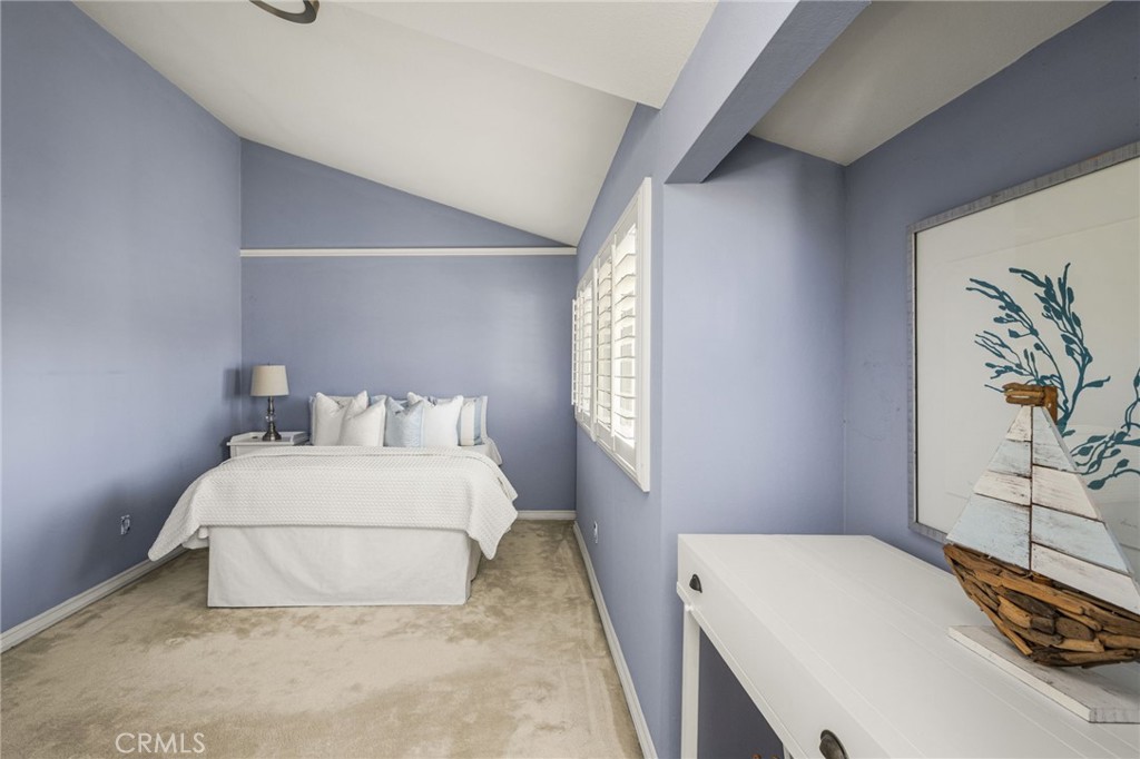 Light-filled guest bedroom features an airy ceiling and a comfortable, restful atmosphere. - 12632 Romaine Wy, Garden Grove CA 92845 - photo 38