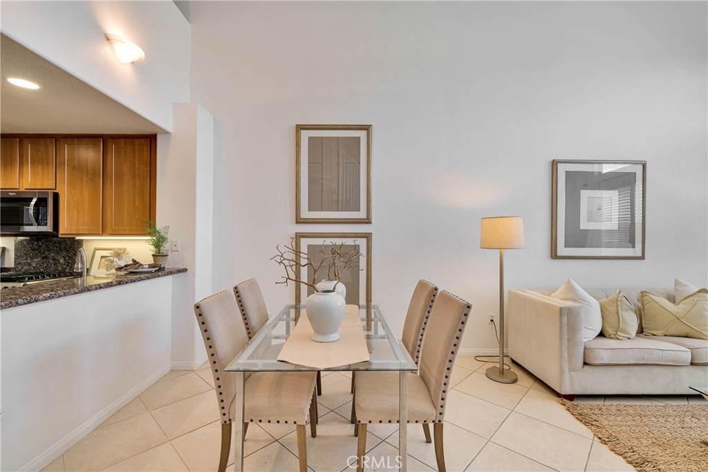 Contemporary open floor plan between living and dining area, crowned with double height ceiling. 16X16, neutral colored - 12664 Chapman Avenue 1402, Garden Grove CA 92840 - photo 2