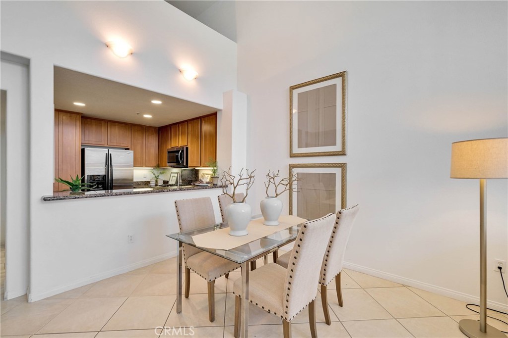 Note the breakfast counter bar extended from the kitchen area - 12664 Chapman Avenue 1402, Garden Grove CA 92840 - photo 3