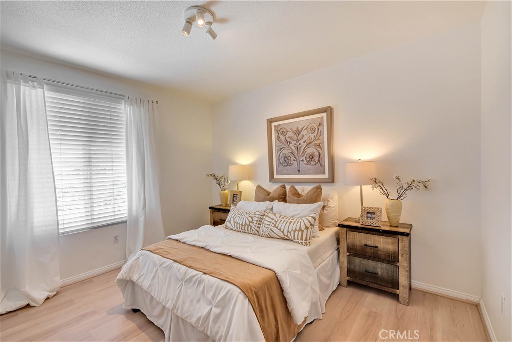 Calm and relaxing primary bedroom with full sized window that looks out to the community pool area - 12664 Chapman Avenue 1402, Garden Grove CA 92840 - photo 13