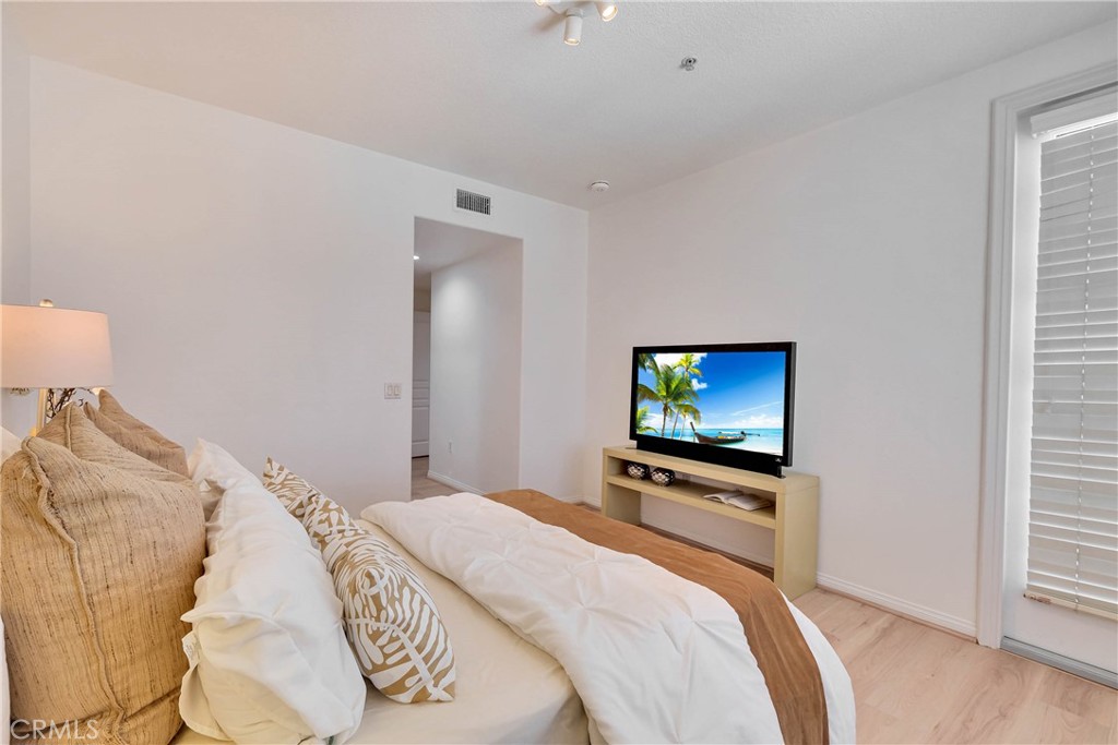 Calm and relaxing primary bedroom with full sized window that looks out to the community pool area - 12664 Chapman Avenue 1402, Garden Grove CA 92840 - photo 14