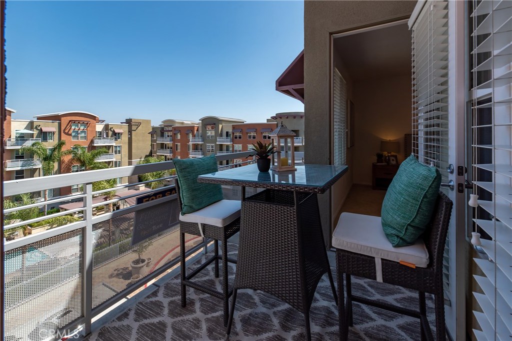 Top floor balcony that looks out to the pool area and outdoor amenities - 12664 Chapman Avenue 1402, Garden Grove CA 92840 - photo 29