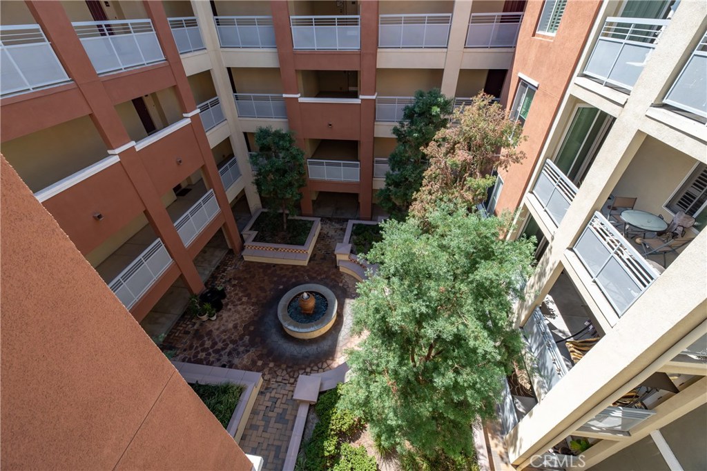 Common area adorned with fountain that can be appreciated while walking the outdoor common hallways - 12664 Chapman Avenue 1402, Garden Grove CA 92840 - photo 34