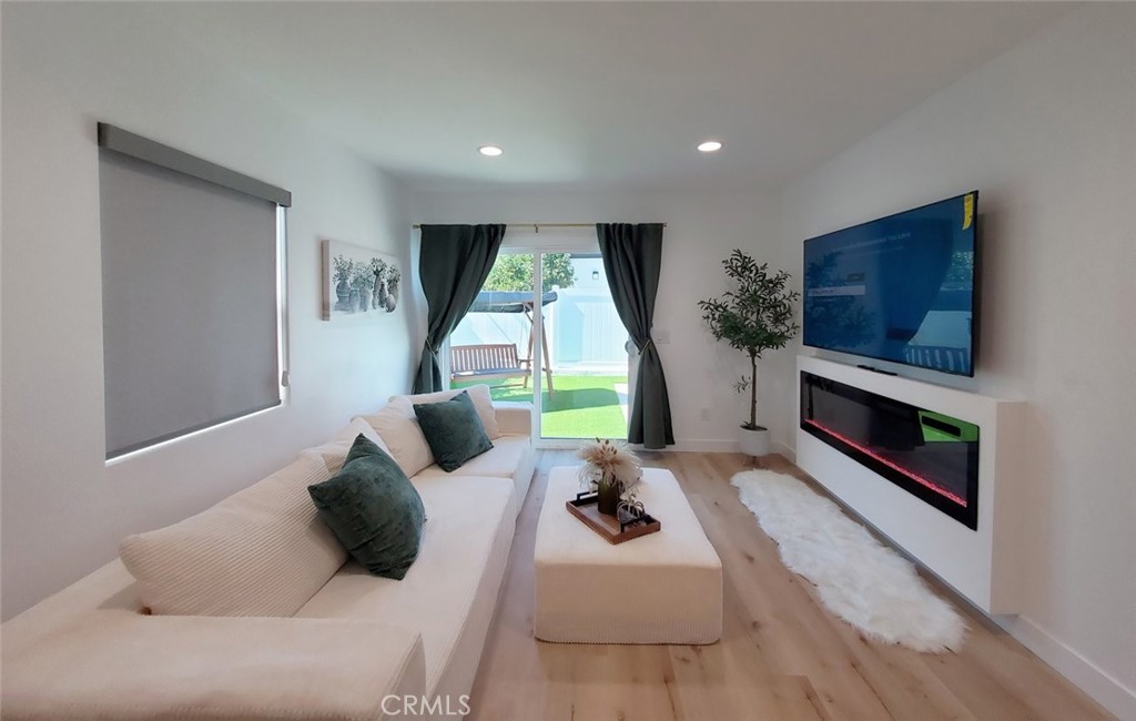 Detached ADU FONDREN- Living room with TV & fireplace - 13392 Laramore, Garden Grove CA 92843 - photo 30