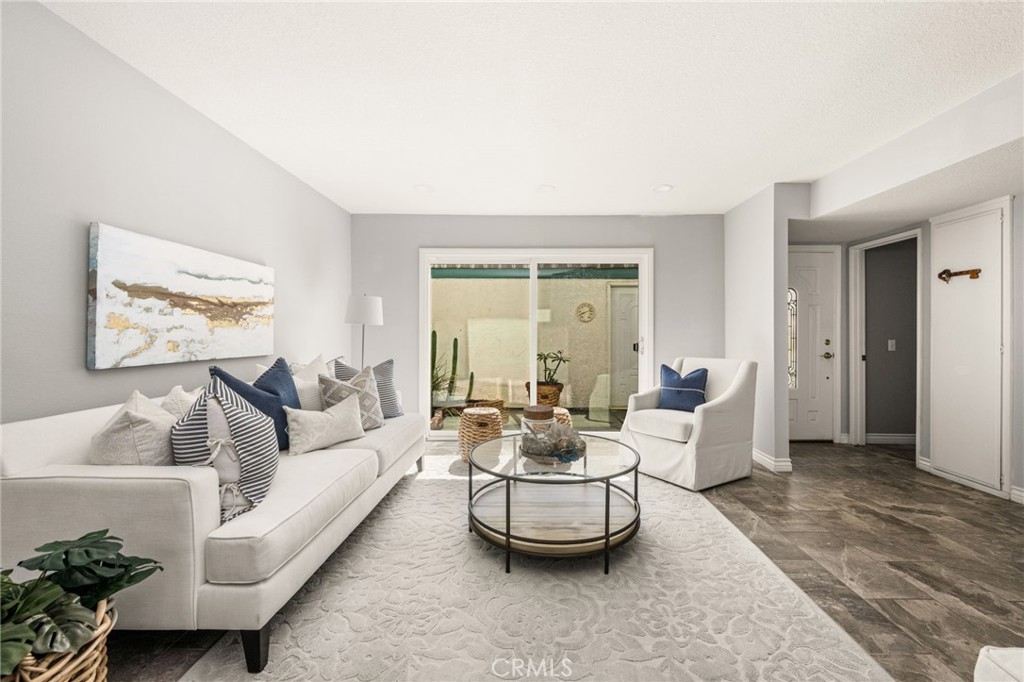xpansive living area with beautiful tile flooring and a seamless connection to the private patio. - 6931 Danvers Dr, Garden Grove CA 92845 - photo 8