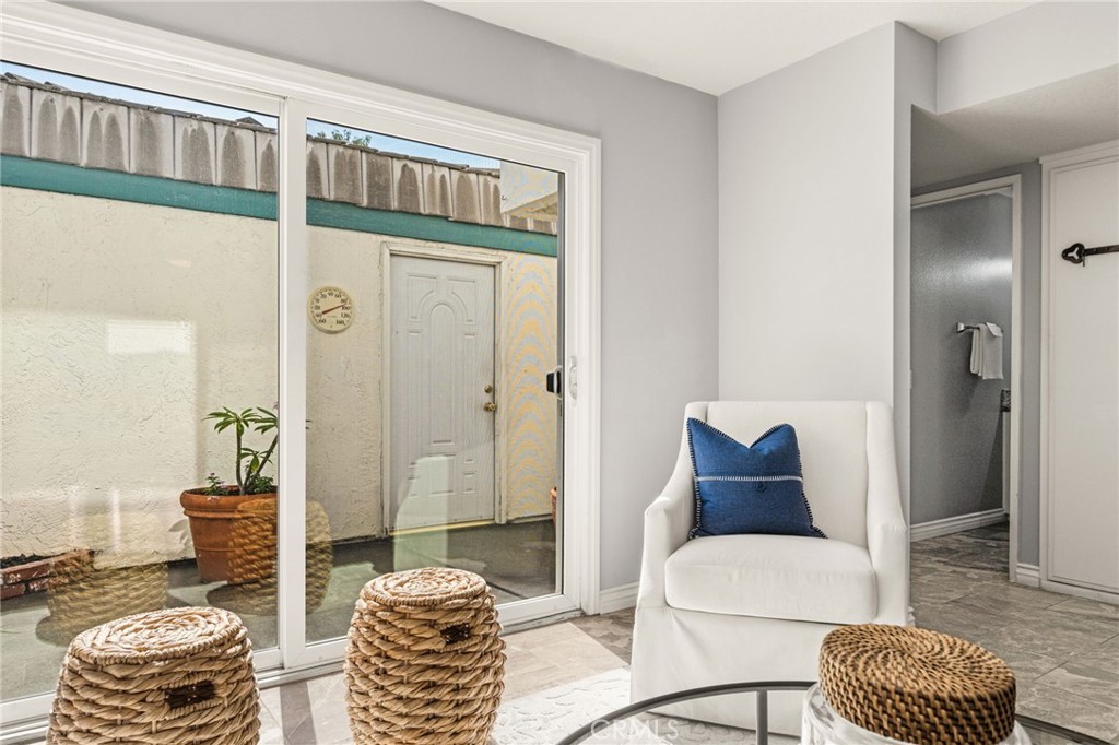 Large sliding glass doors bring the outdoors in and provide access to an enclosed patio. - 6931 Danvers Dr, Garden Grove CA 92845 - photo 10