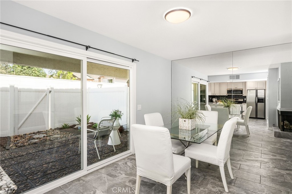ndoor-outdoor dining made easy, with wide sliding glass doors opening directly to the enclosed patio. - 6931 Danvers Dr, Garden Grove CA 92845 - photo 21
