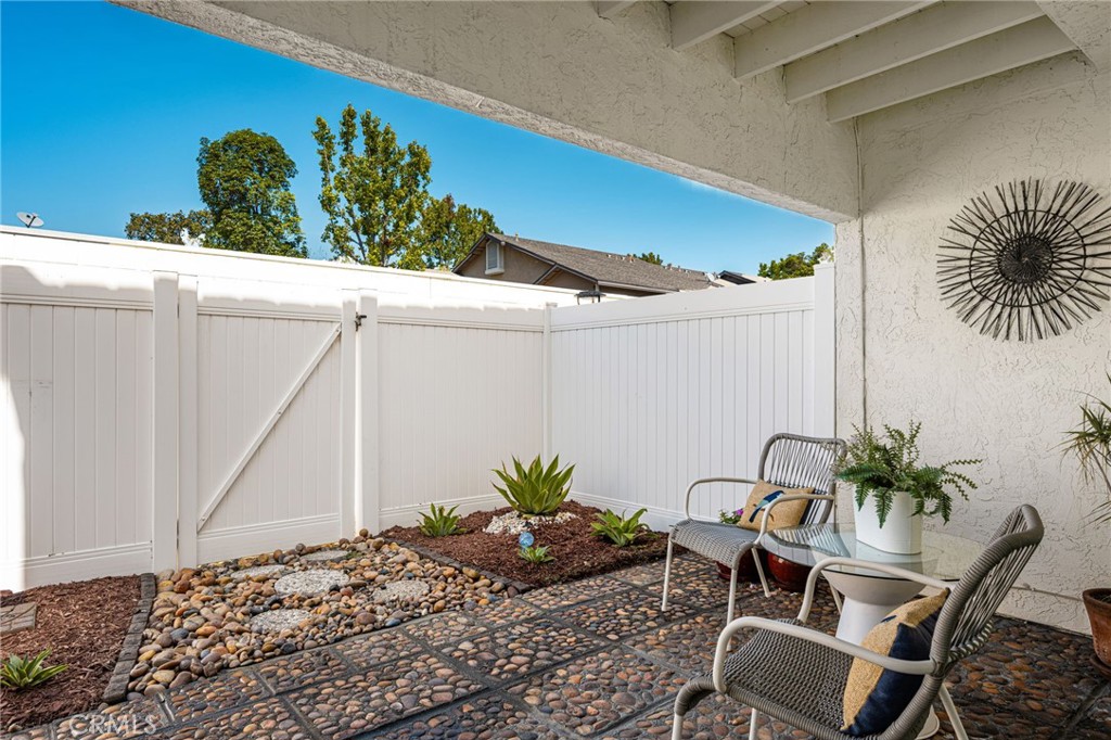 Patio: Your own private outdoor retreat! Decorative pebble paving, landscaped garden beds, and a covered seating area cr - 6931 Danvers Dr, Garden Grove CA 92845 - photo 22