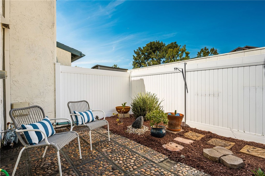 Patio Spacious patio with attractive pebble paving, colorful plantings, and sliding glass doors for easy indoor-outdoor - 6931 Danvers Dr, Garden Grove CA 92845 - photo 24