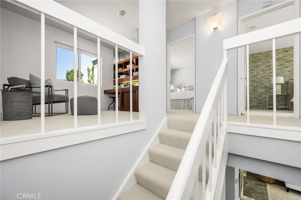 Carpeted stairs lead to the second level, accented by crisp white paneling. - 6931 Danvers Dr, Garden Grove CA 92845 - photo 31